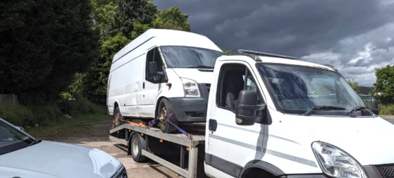 A white van on a recovery truck 